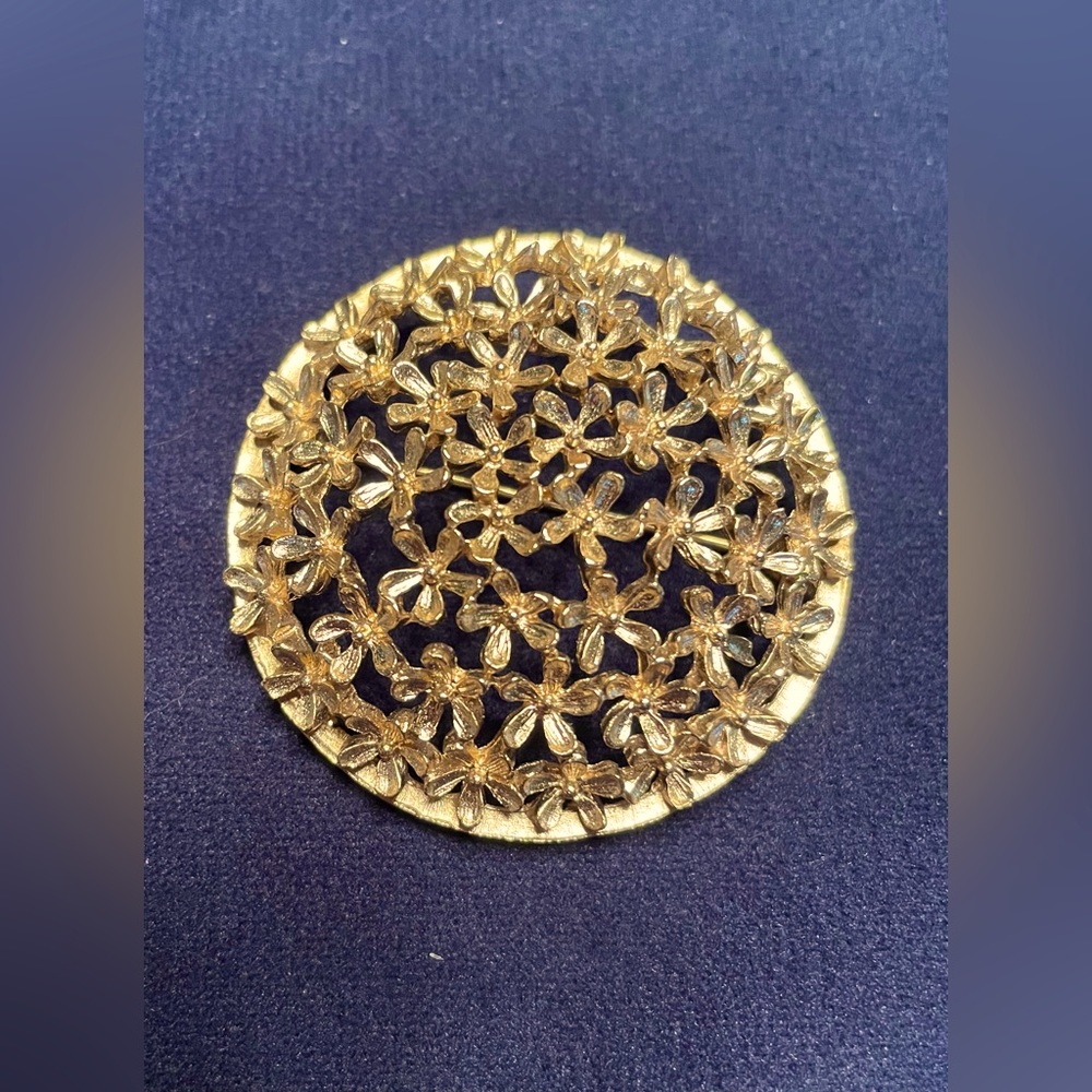 Gold colored floral brooch